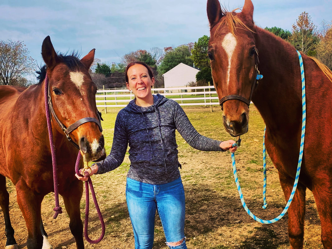 Therapist Cindy Cisneros with horses in field, smiling | Eldersburg Equine Psychotherapy, horse therapy in Eldersbug, Maryland, therapy with horses for anxiety, depression, ADHD, trauma, and neurodiversity, learn life skills and reduce symptoms with therapy with horses